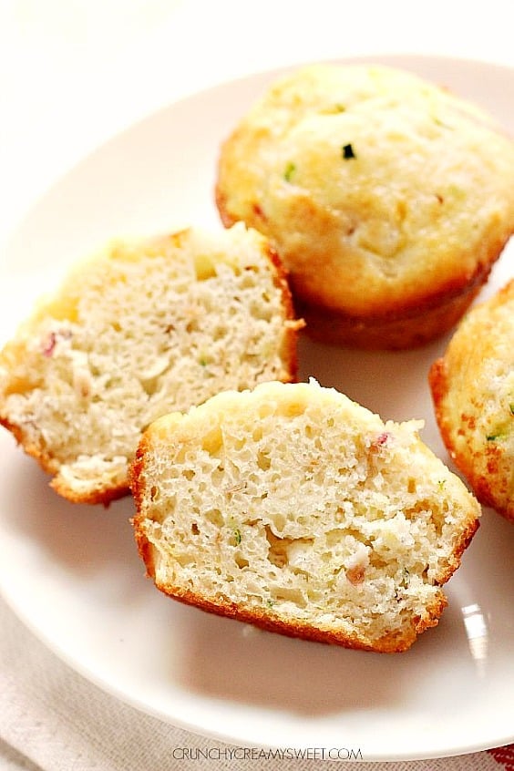 Overhead shot of three zucchini apple muffins, one cut in half to show center.