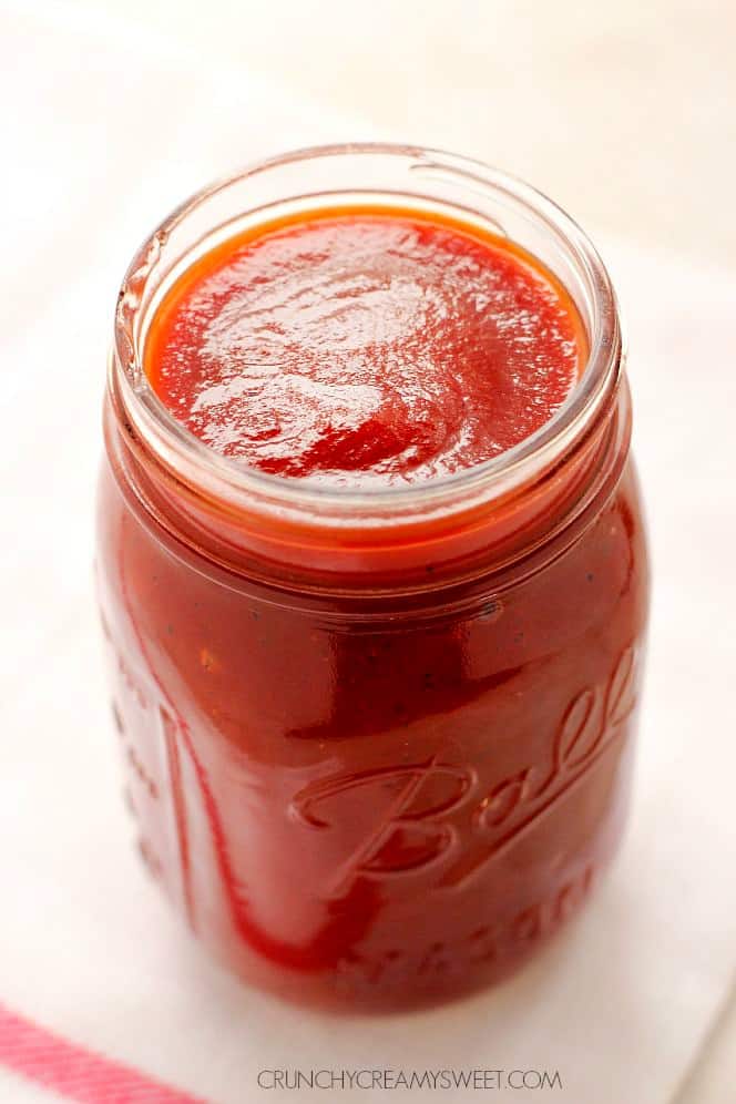 Best Homemade BBQ Sauce - quick and easy barbecue sauce that will take your grill game to the next level! It's sweet, smoky and slightly spicy. Side shot of BBQ sauce in a jar.