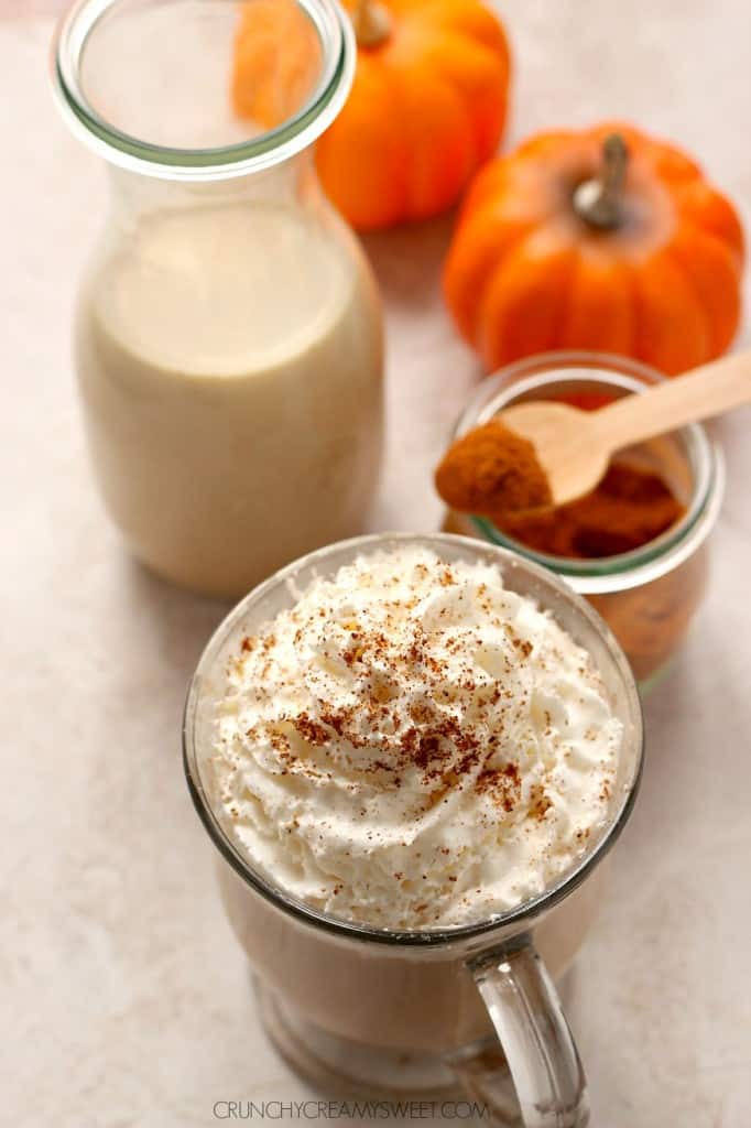 Overhead shot of pumpkin spice coffee creamer in coffee with whipped cream on top.