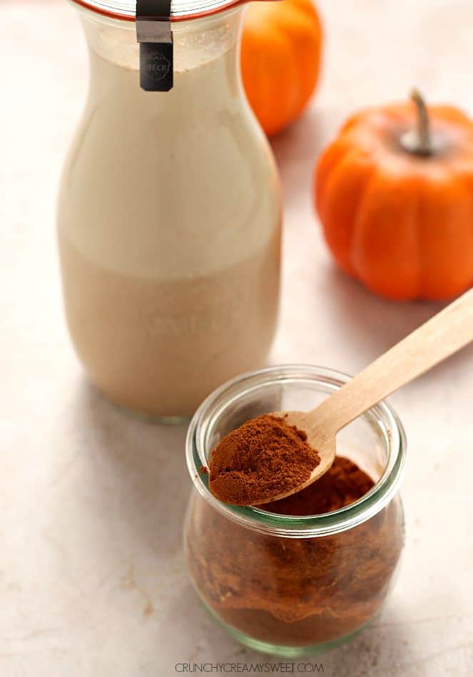 Side shot of homemade pumpkin pie spice in small jar.