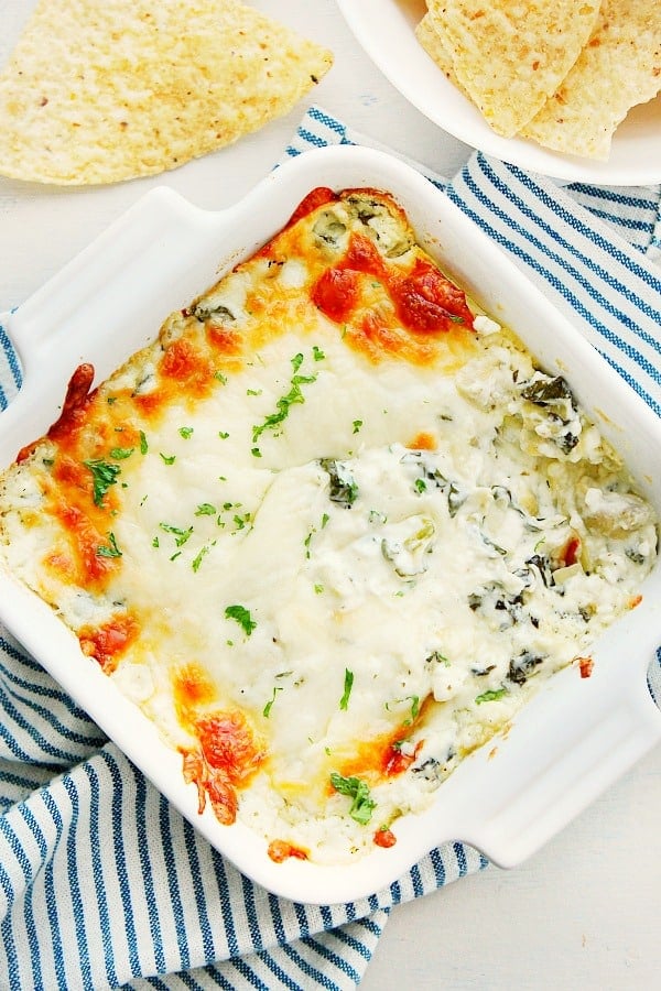 Spinach Artichoke Dip in white baking dish.