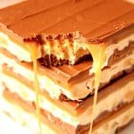 Homemade Snickers bars stacked up on each other.