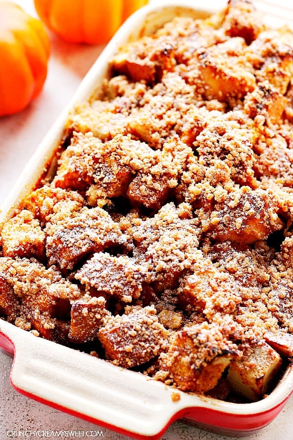Pumpkin French Toast Casserole - your favorite breakfast made the easy way! French toast bake with pumpkin and spice and my best crumb topping. You can even make it the night before! Pumpkin French Toast Casserole in a baking dish.
