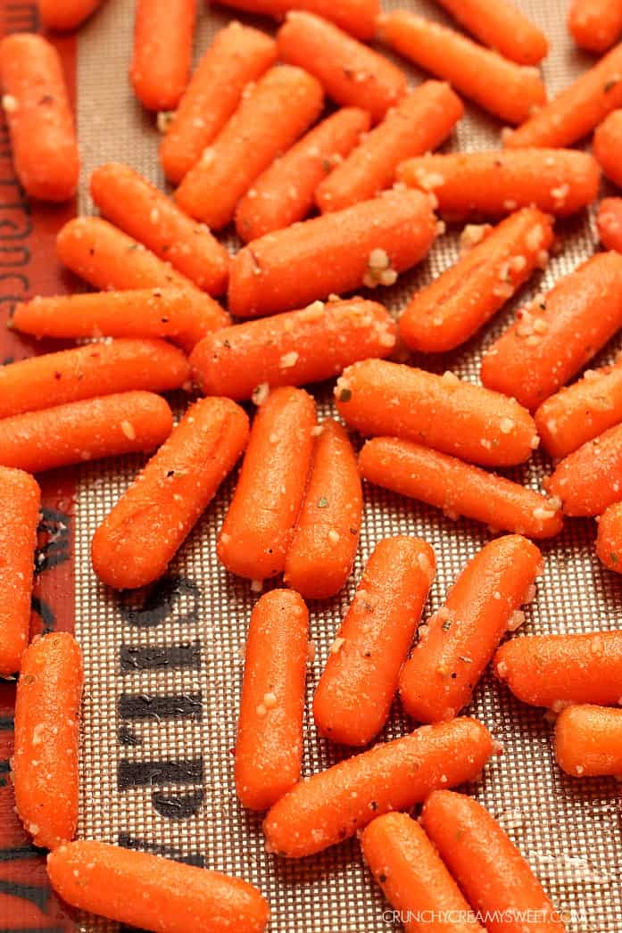 Easy Garlic Parmesan Roasted Baby Carrots - roasting carrots brings out their sweetness and rich flavor! Adding garlic, Parmesan and oregano makes them irresistible! 