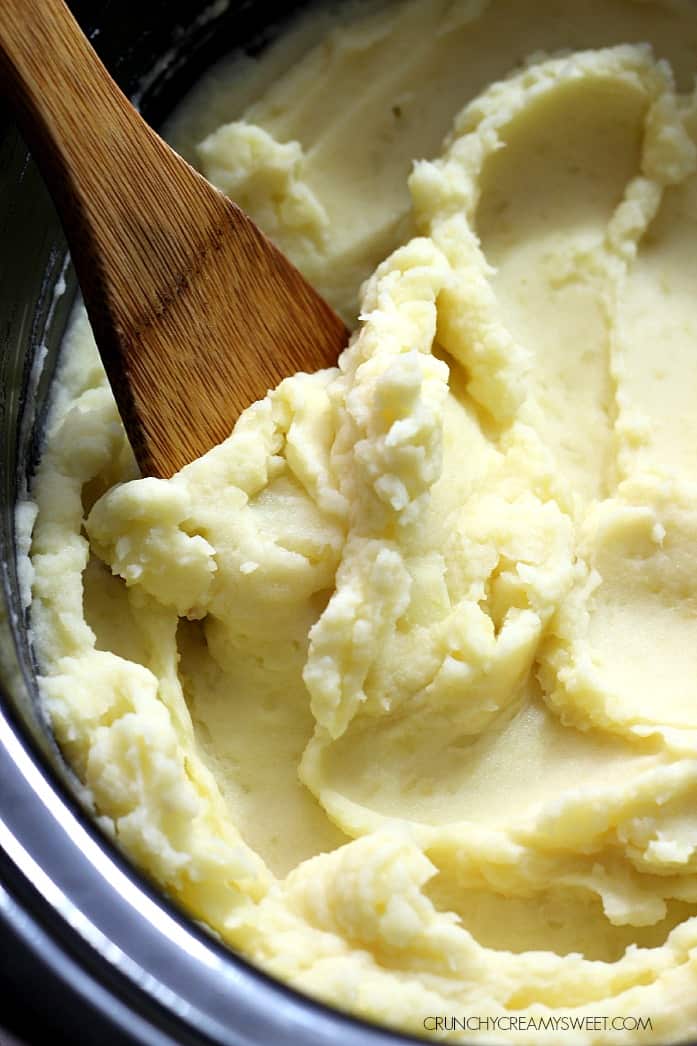 Close up shot of mashed potatoes in a slow cooker.