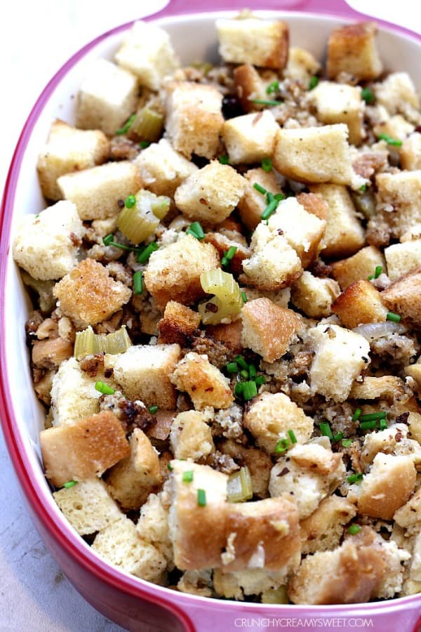 Slow Cooker Sausage Stuffing - save time and oven space this Thanksgiving! This slow cooker stuffing is easy, perfectly moist and delicious! You have to have it on your holiday table! Slow Cooker Sausage in a casserole dish.