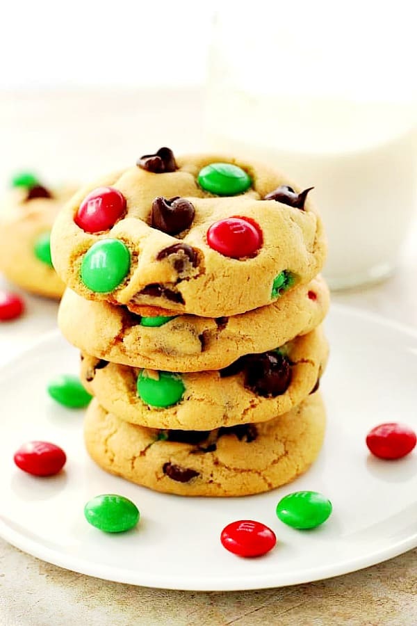 Christmas M&M Cookies stacked on white plate.