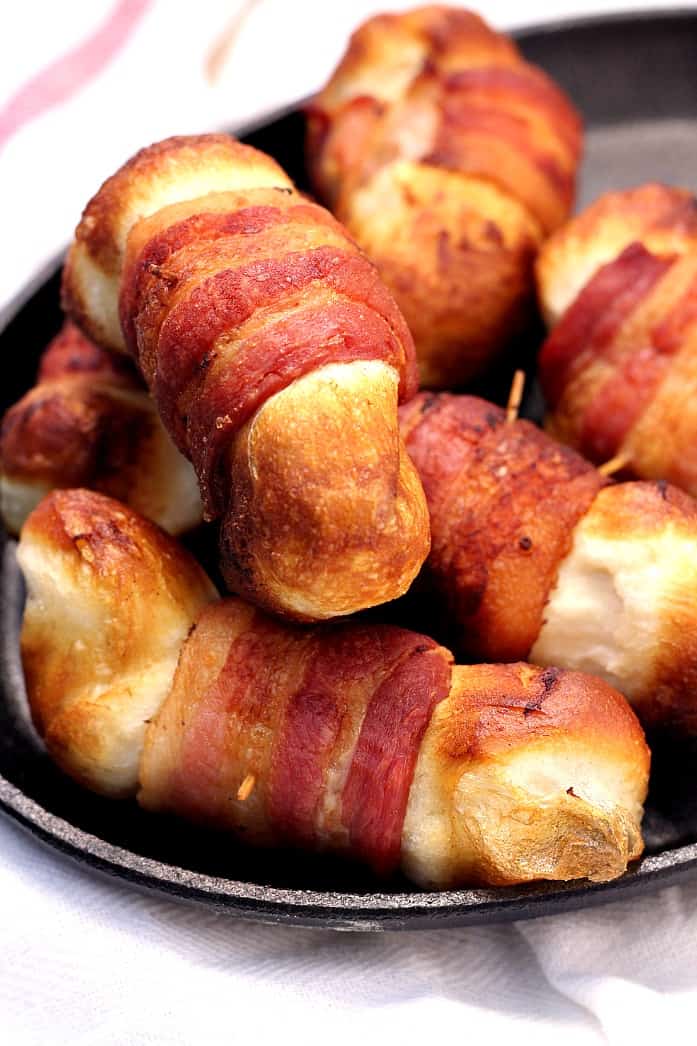 Bacon Wrapped Cheese Bombs - the appetizer that will make the party! Cheese filled biscuit bombs wrapped in bacon and fried. Do it!