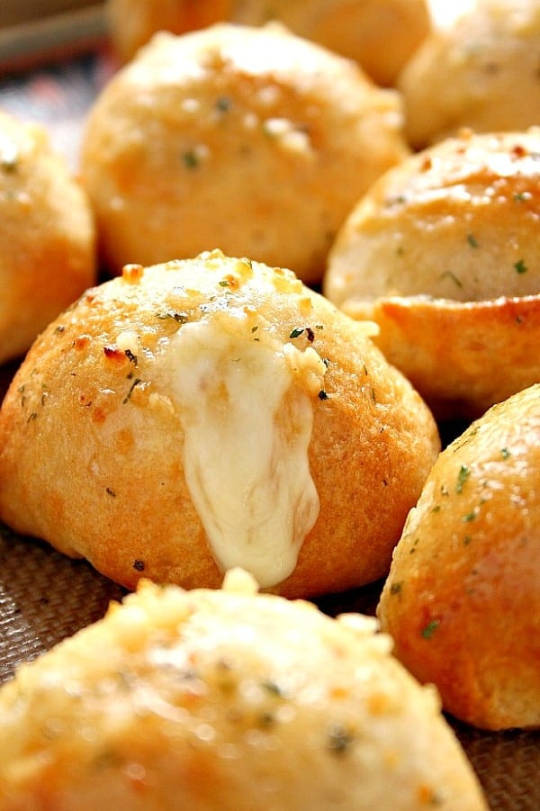 Garlic cheese bombs rolls on baking sheet. 