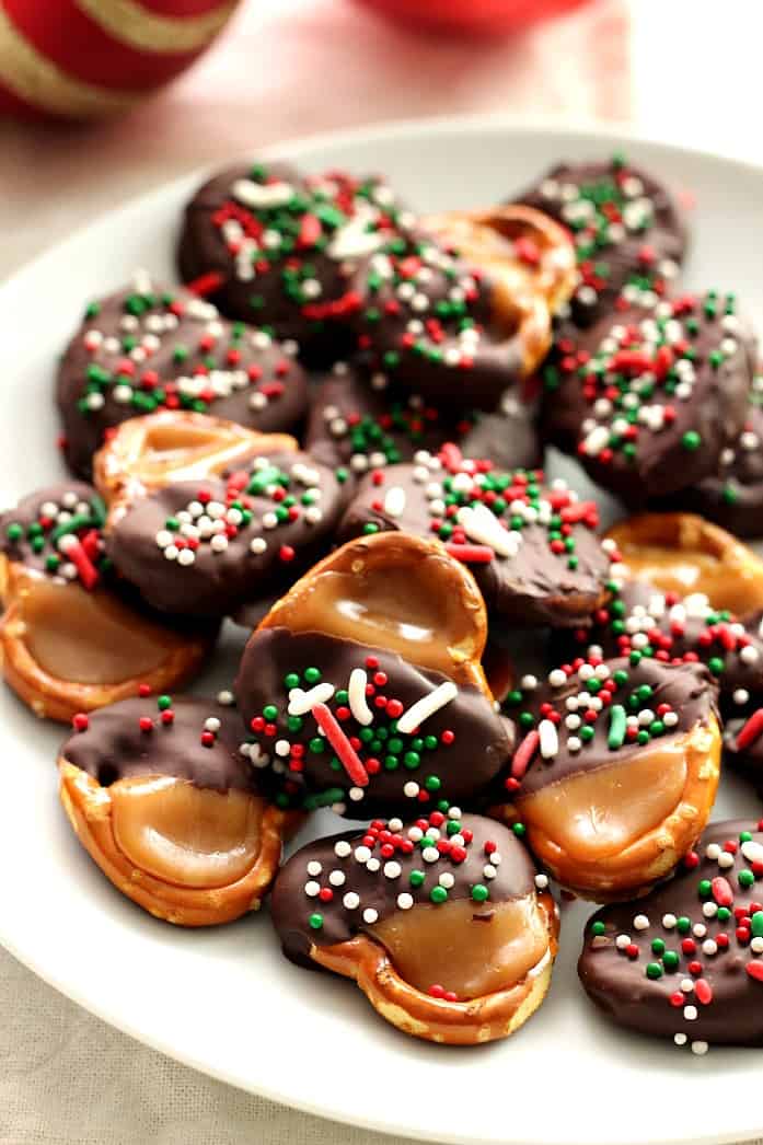 Pretzel bites dipped in chocolate on a plate.