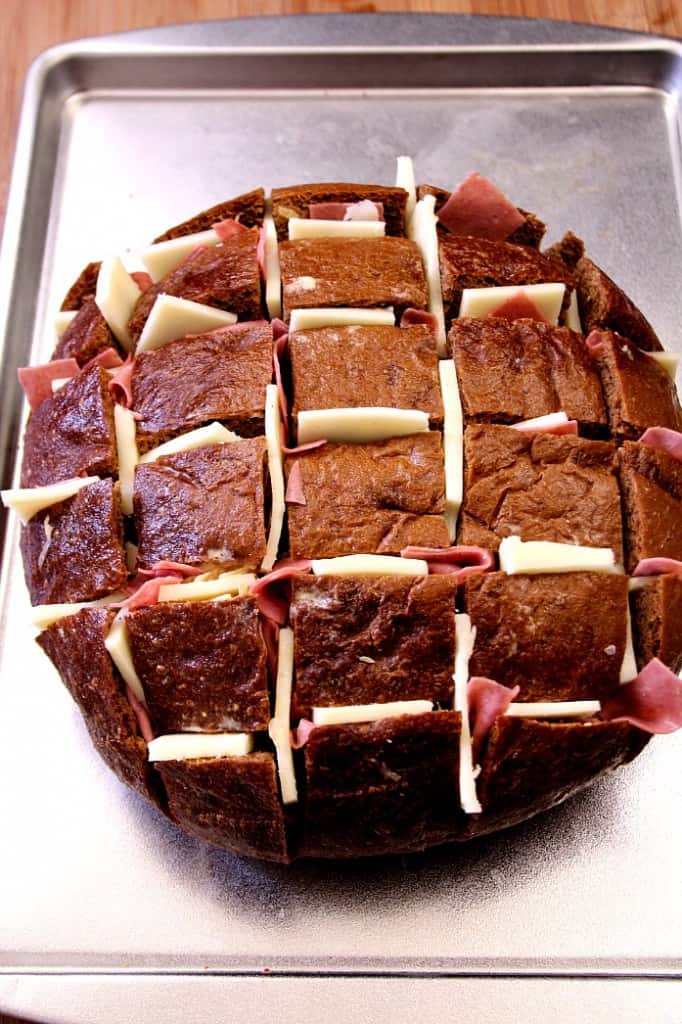 Easy Cheesy Reuben Pull Apart Bread - this one is EPIC! Pumpernickel bread filled with Thousand Island dressing, sauerkraut, corned beef and lots of cheese! Pull apart bread Reuben style! 