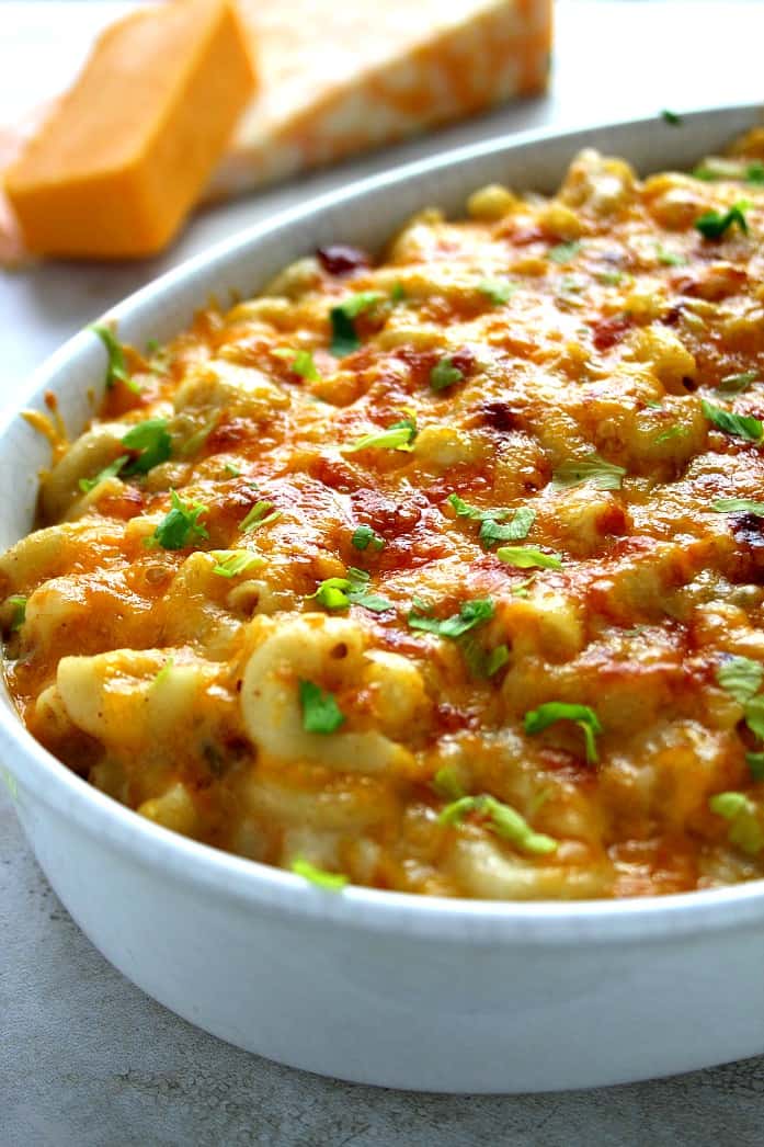 Side shot of cheesy mac and cheese in white casserole dish.