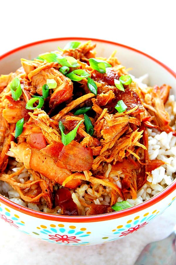 Teriyaki chicken on rice in bowl.