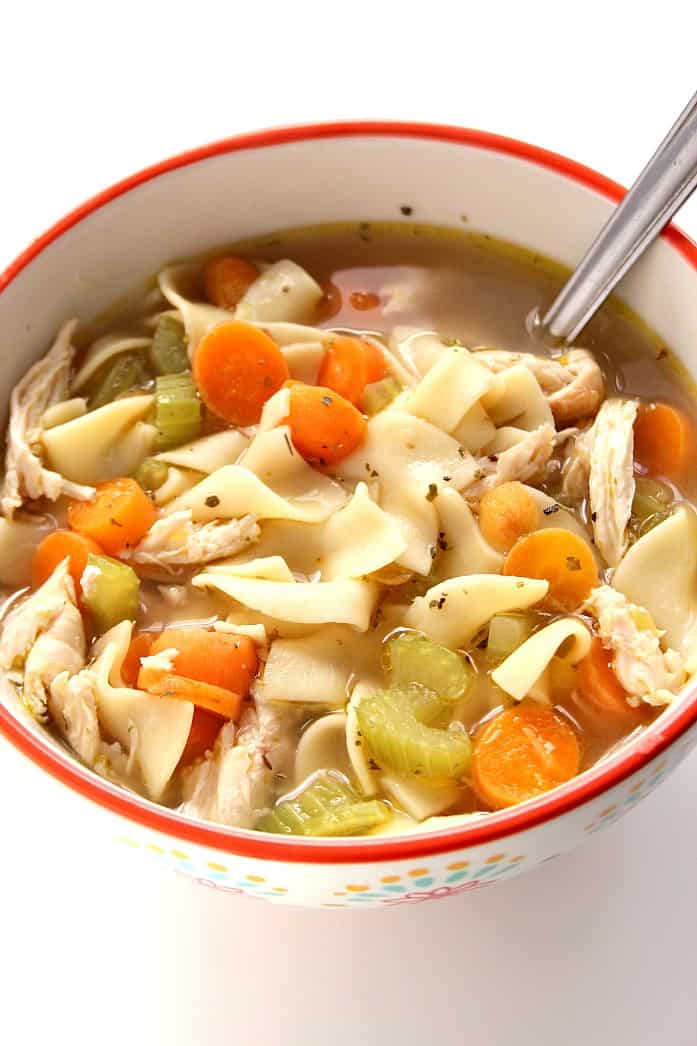 Side shot of bowl of chicken noodle soup.