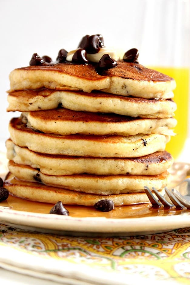 Side shot of tower of pancakes with chocolate chips.