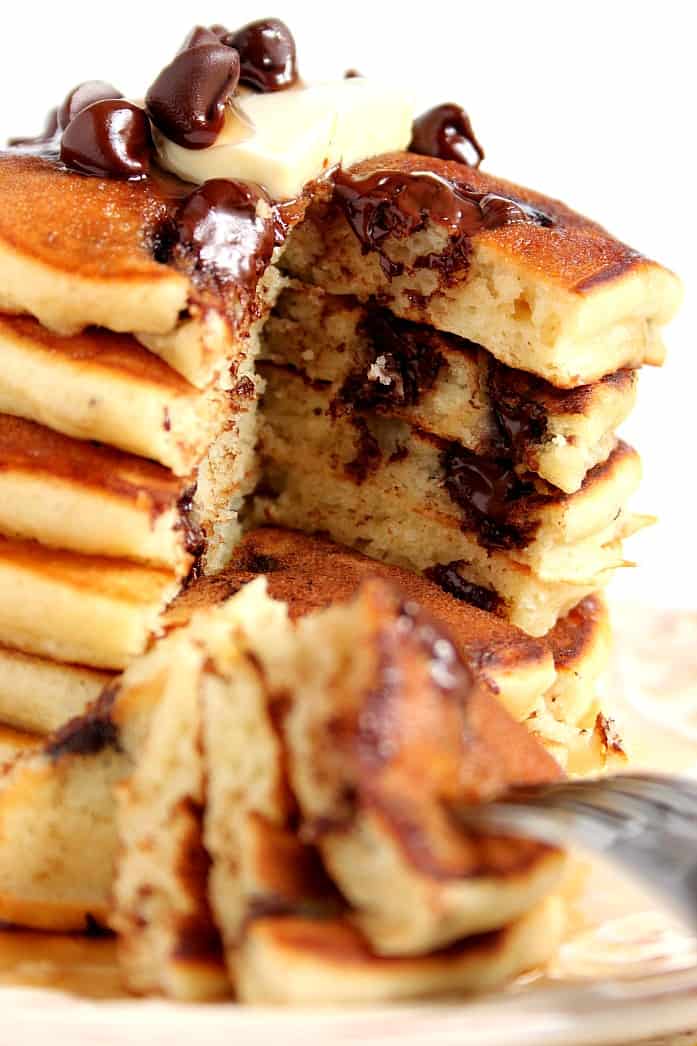 Close up of cut out in tower of pancakes with chocolate chips.