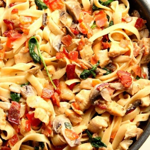 Creamy Mushroom Chicken Pasta with bacon in skillet.