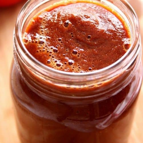 Blender Enchilada Sauce in a glass jar.