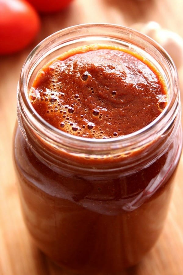 Blender Enchilada Sauce in a glass jar.