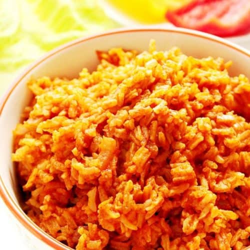 Spanish rice in a bowl with red rim.