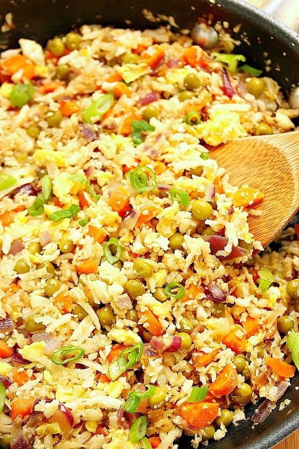 Cauliflower Fried Rice - this healthy, low-carb version of a popular takeout dish. It takes about 20 minutes to make, including grating the cauliflower. Fried rice in pan.