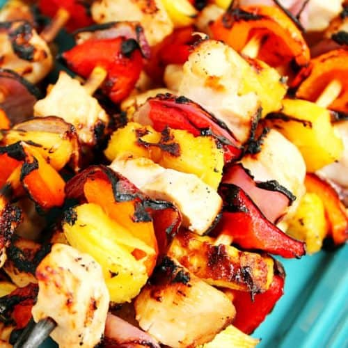 Pineapple Chicken Kabobs on skewers on a platter.