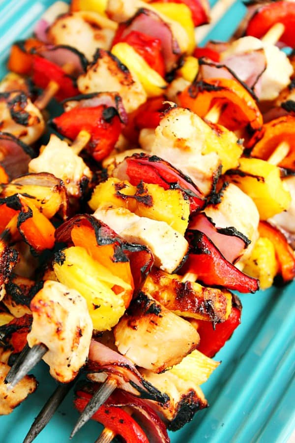 Pineapple Chicken Kabobs on skewers on a platter.