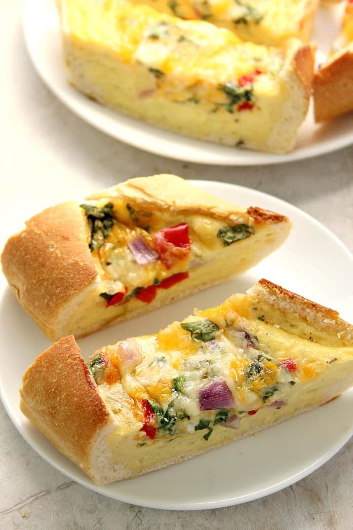 Cheesy Egg Boats recipe - I turned a baguette into a bread boat filled with eggs, cheese and veggies! Perfectly crunchy edges, cheesy filling with lots of flavor from peppers, onions and Monterey Jack cheese. Use Take & Bake baguette for that freshly baked flavor and texture! 