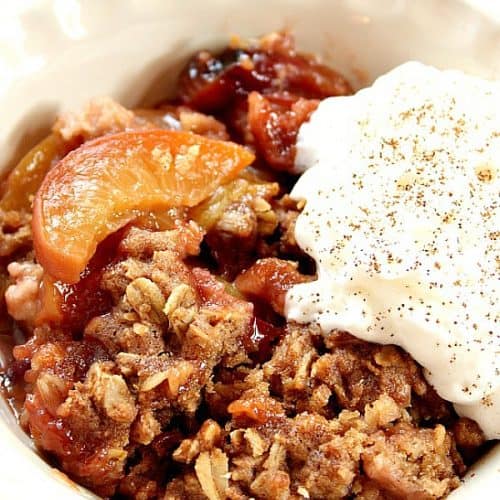 Slow Cooker Peach Crisp in a bowl with ice cream.