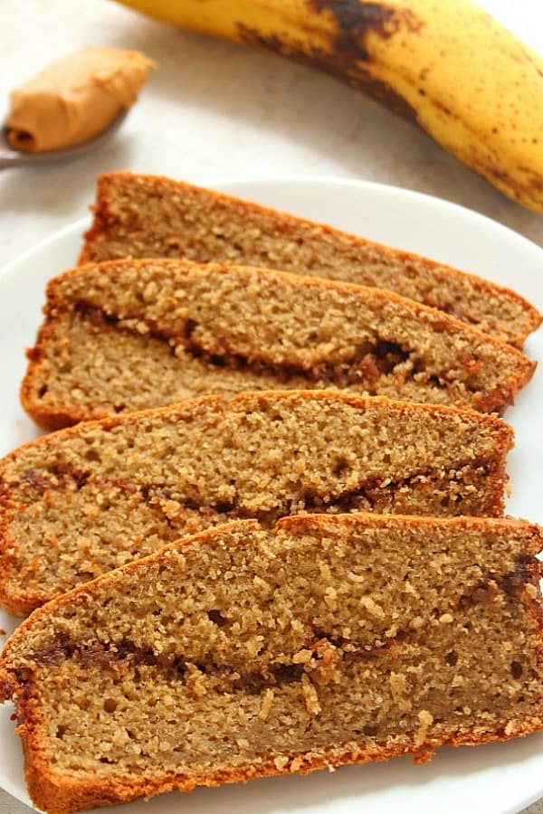 Peanut Butter Banana Blender Bread recipe - this quick bread couldn't be faster to make! Mix all ingredients in a blender, pour into a pan and bake! No flour, no white sugar yet sweet and delicious! Sliced Blender Banana Bread on a plate.