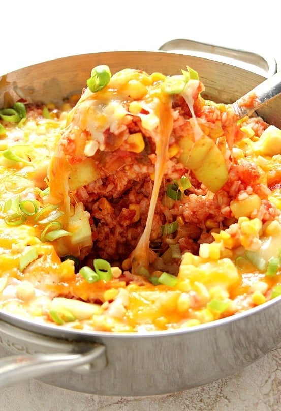 Cheesy Salsa Rice with Zucchini and Corn recipe - my new favorite way to take plain rice to a new level! Perfect side dish to tacos, enchiladas or burritos OR turned into a full meal by adding protein. Quick, easy and irresistible!