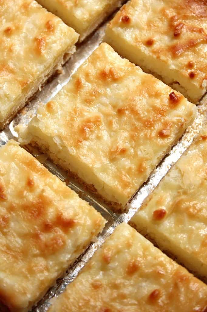 Overhead shot of sliced coconut cheesecake bars.