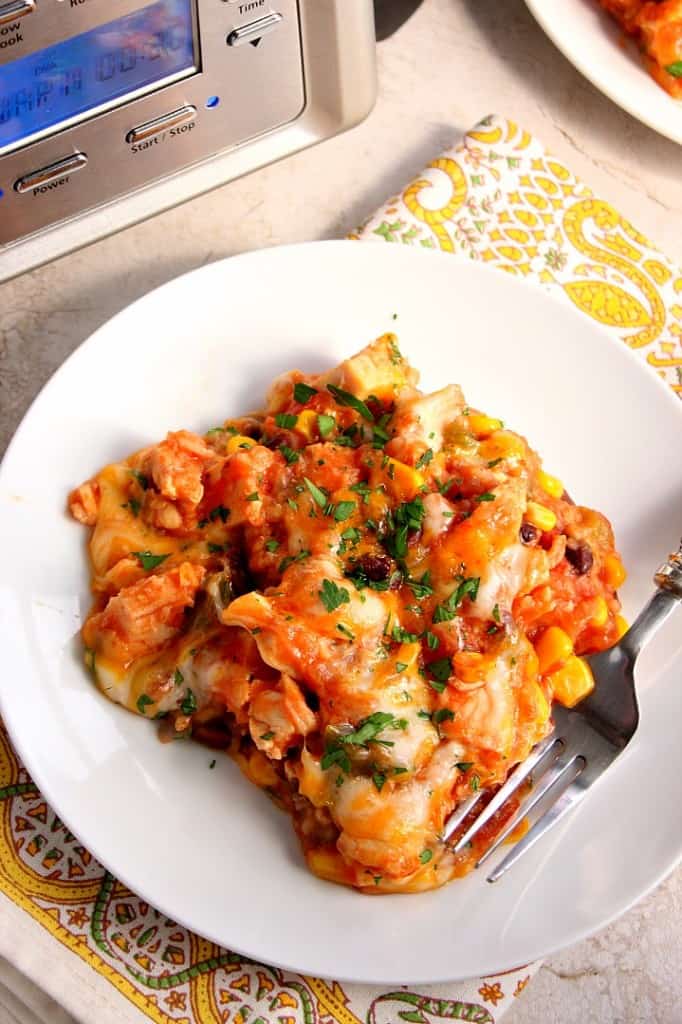 Southwestern Crock-Pot Chicken and Rice recipe - cheesy chicken, vegetable and rice dish made in a slow cooker for an easy weeknight dinner. Peppers, corn, beans and a good mix of spices add a Southwestern flair to a classic. 