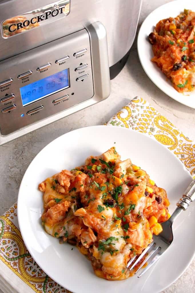 Southwestern Crock-Pot Chicken and Rice recipe - cheesy chicken, vegetable and rice dish made in a slow cooker for an easy weeknight dinner. Peppers, corn, beans and a good mix of spices add a Southwestern flair to a classic. 