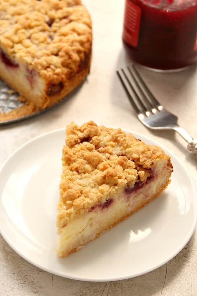 Raspberry Coconut Sour Cream Crumb Pie Recipe - sweet and creamy coconut filling with tarty raspberry jam, all under a buttery crunchy crumb topping. This pie is easy and absolutely delicious!