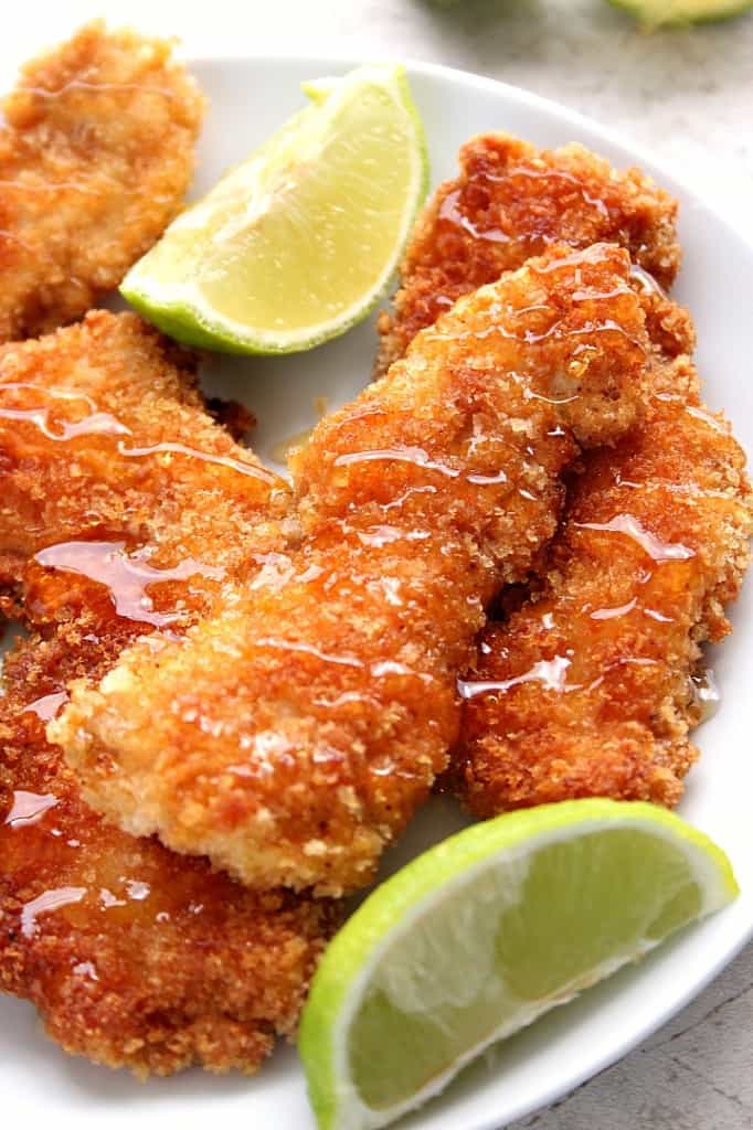 Crunchy Honey Lime Chicken Recipe - crispy panko-crusted chicken tenders, drizzled with lime juice and sweet honey. This family friendly dinner idea is a huge hit every single time!