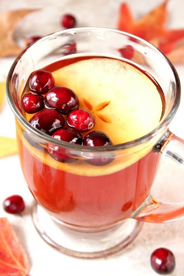 Apple Cranberry Slow Cooker Tea Recipe - warm and cozy tea with fresh cranberries and apples, cooked in slow cooker. Perfect for chilly fall and winter days! Apple Cranberry Tea in a mug.