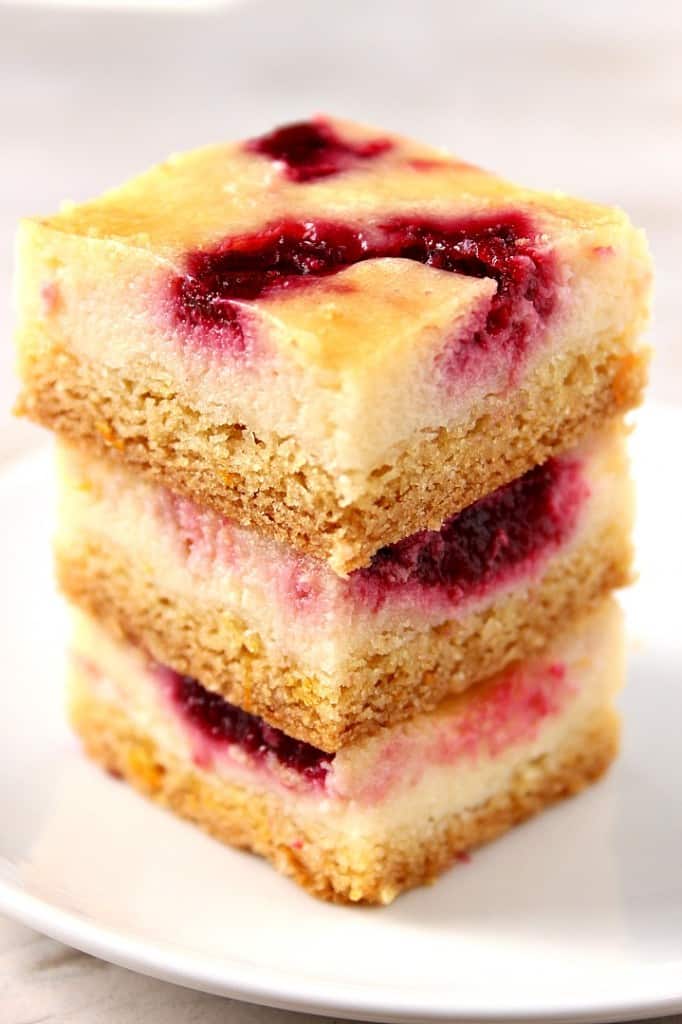 Cranberry Orange Sour Cream Bars recipe - easy dessert idea for the holidays! These sour cream bars with orange and cranberry jam swirls baked on a cookie crust will look festive on any holiday table.