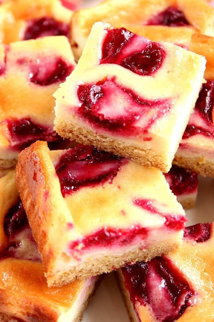 Cranberry Orange Sour Cream Bars recipe - easy dessert idea for the holidays! These sour cream bars with orange and cranberry jam swirls baked on a cookie crust will look festive on any holiday table.