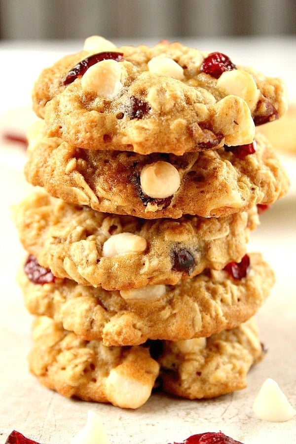 Cranberry White Chocolate Oatmeal Cookies Recipe - chewy oatmeal cookies filled with dried cranberries and white chocolate chips! It's quick and easy to make a batch and enjoy with a glass of milk! Cranberry White Chocolate Oatmeal Cookies stacked up.