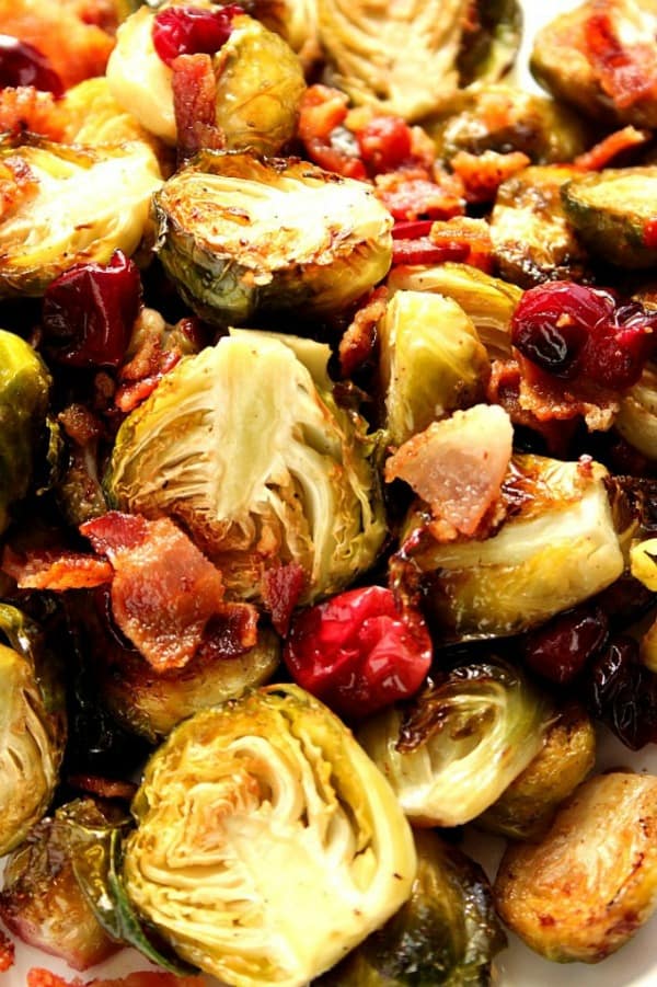 Bacon Roasted Brussels Sprouts with Cranberries Recipe - the BEST WAY to enjoy Brussels sprouts! Bacon roasting in the oven with fresh cranberries makes them quite irresistible. Bacon Cranberry Roasted Brussels Sprouts close up.