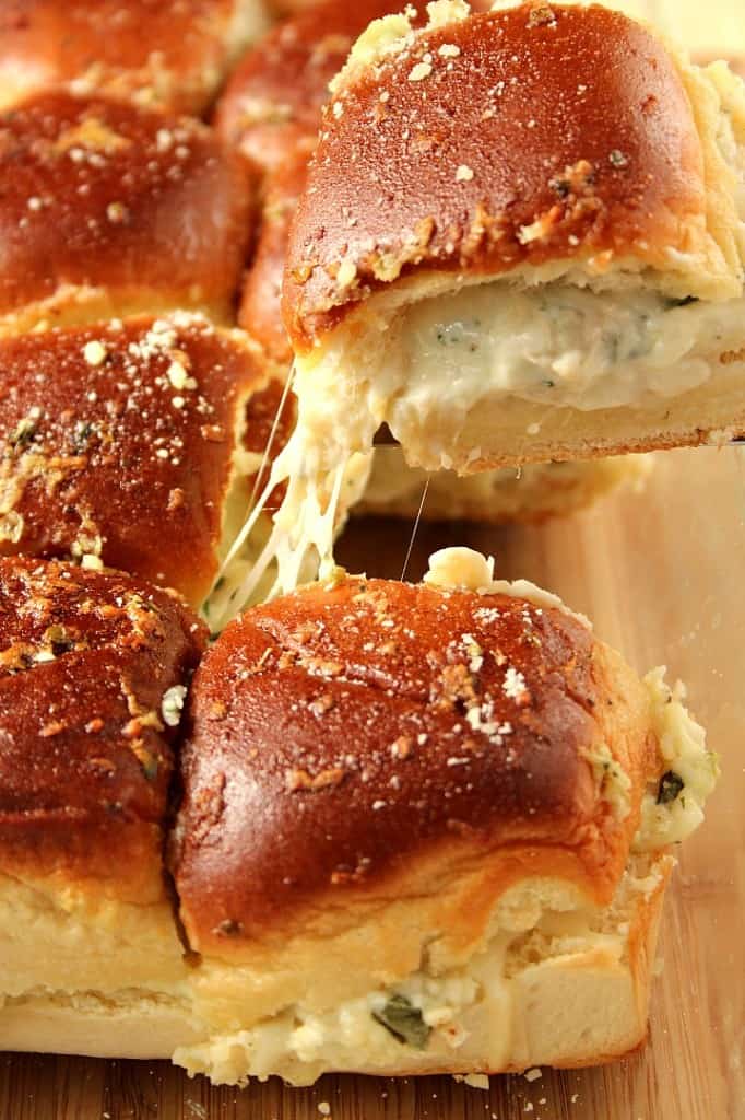 Cheesy Spinach Artichoke Dip Sliders recipe - baked garlic butter slider buns with spinach artichoke dip and cheese. Taking dip to a new level for one amazing party appetizer! 