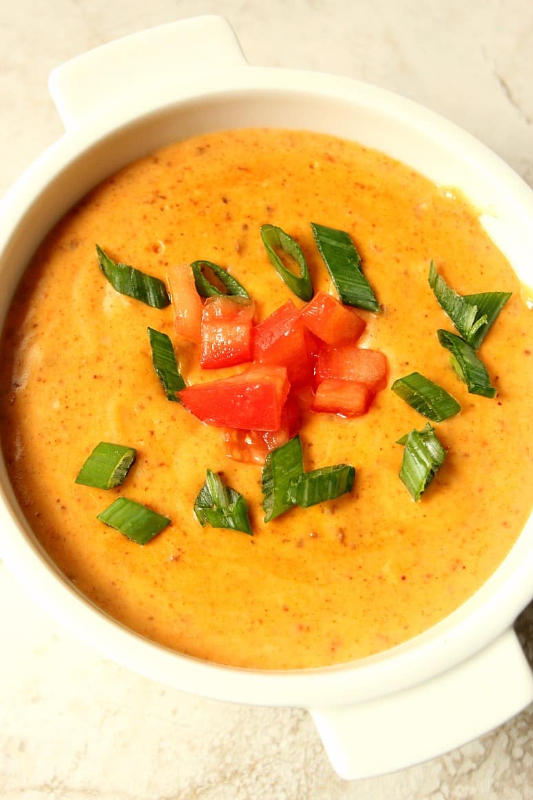 Chili queso dip in a white bowl.