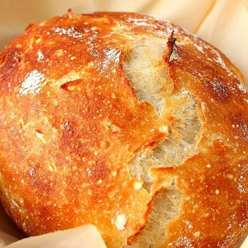 Sourdough bread loaf on parchment paper.