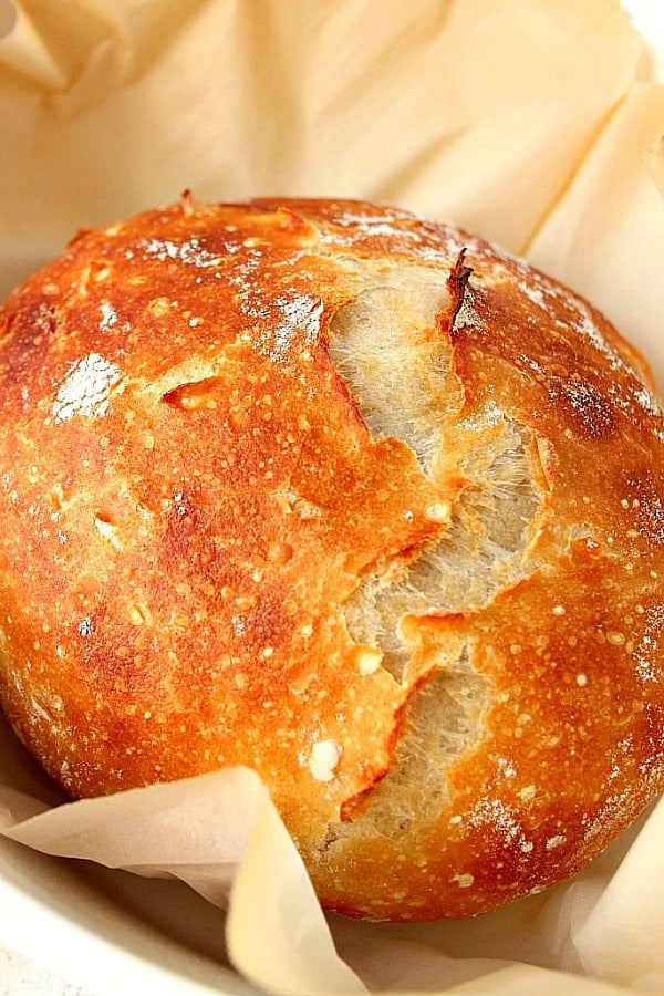 Sourdough bread loaf on parchment paper.