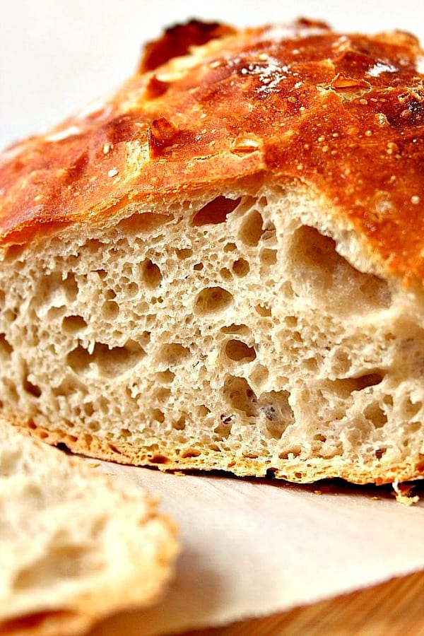 Side shot of cut sourdough bread with golden brown crust.