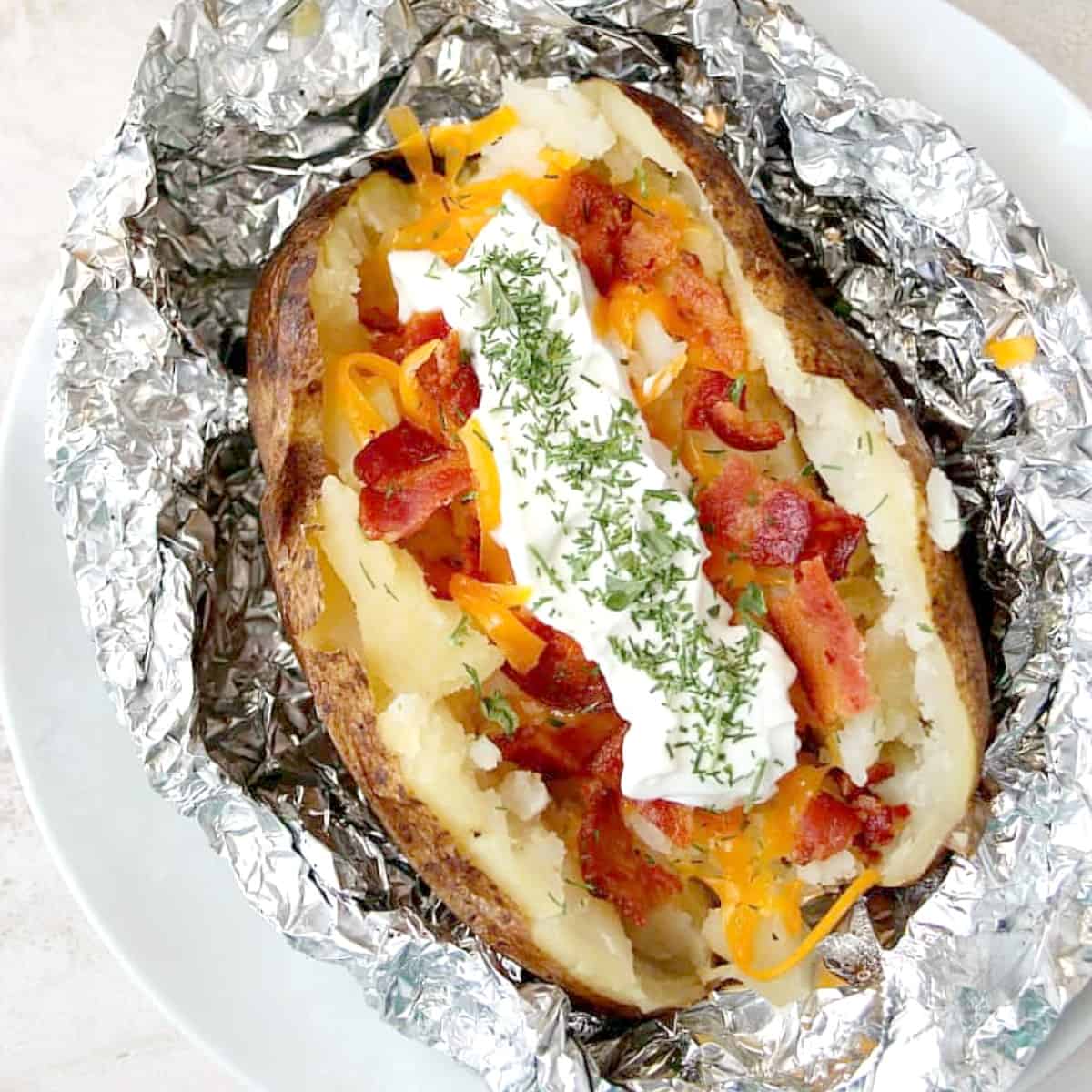 Baked potato in a foil with topping.