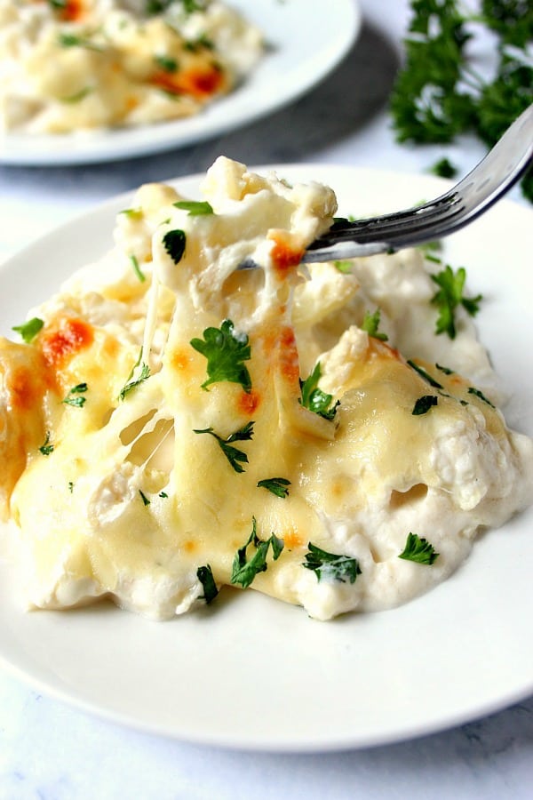 Cheesy Cauliflower Alfredo Bake on plate with fork.