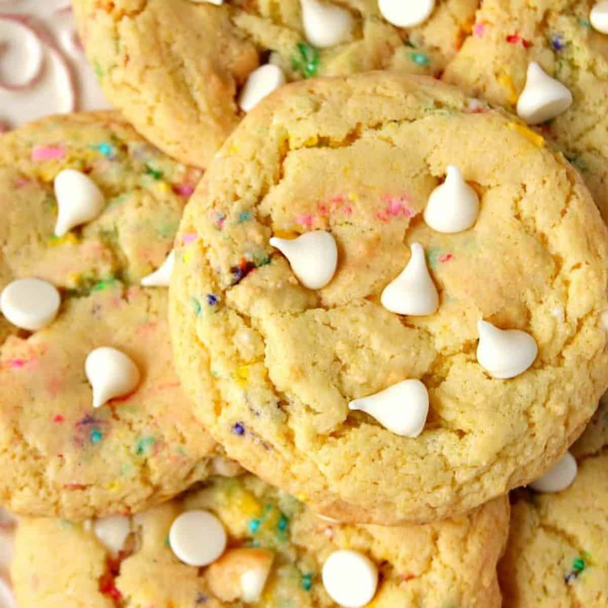 Cookies with white chocolate chips on a plate.