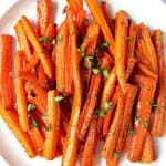 Brown sugar garlic roasted carrots on white plate.